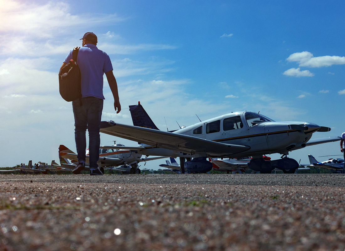 COPA VIP Silver - Man With Backpack Walking Towrad Small Plane to Get Ready for Flight