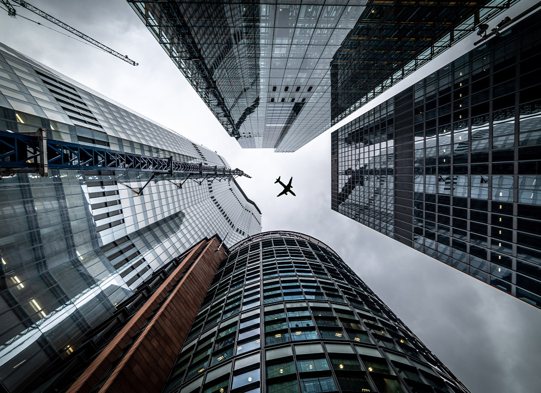 Customer Service Policy - Abstract View Looking Up at Tall Buildings and Plane Overhead