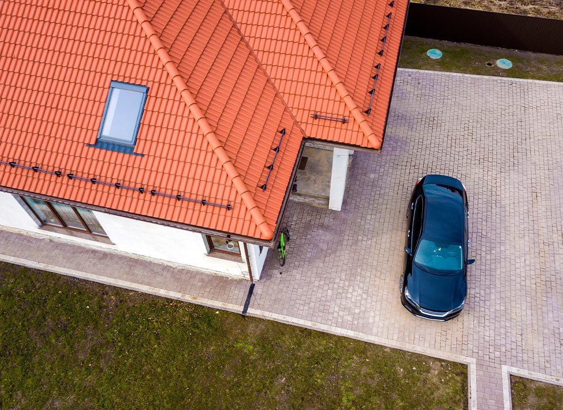 Personal Insurance - Aerial View of Modern Home with Orange Tiled Roof and Car