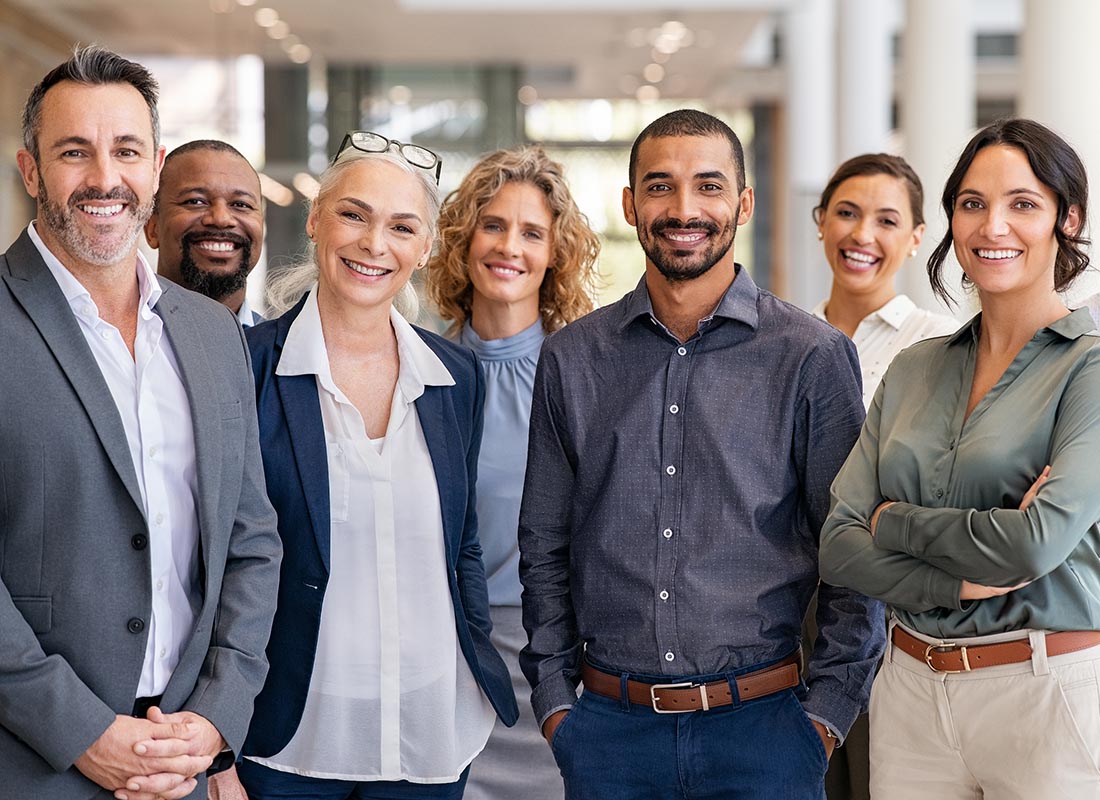 Our Story - Portrait of Smiling Professionals in a Modern Office